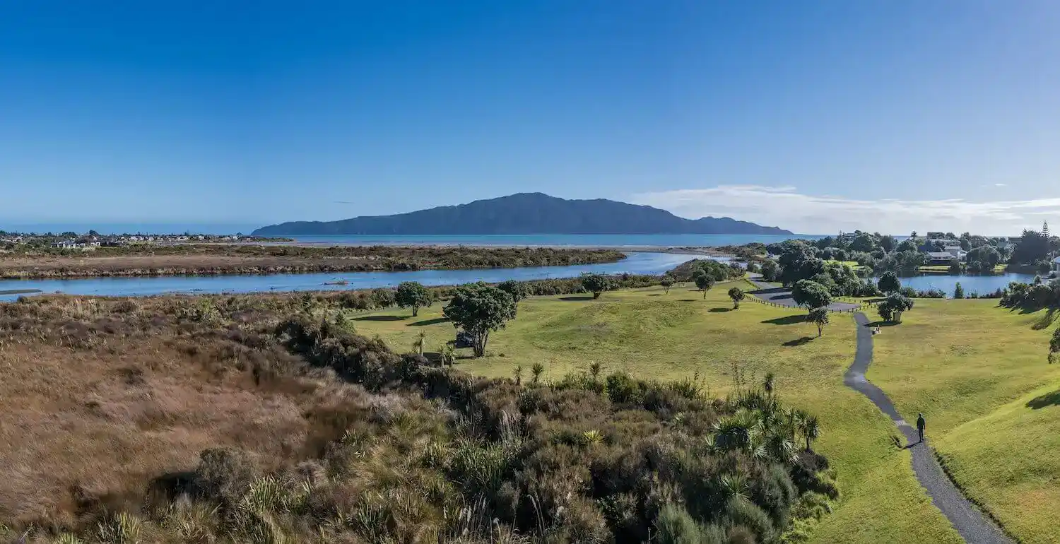 Coastal wetland and green parkland looking out to Kāpiti Island
